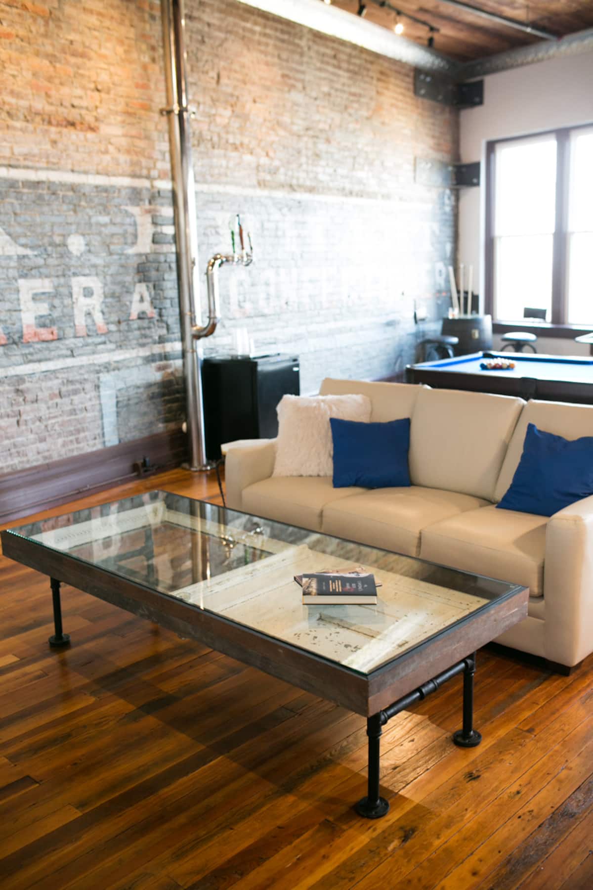 Living room seating beside the original painted brick wall