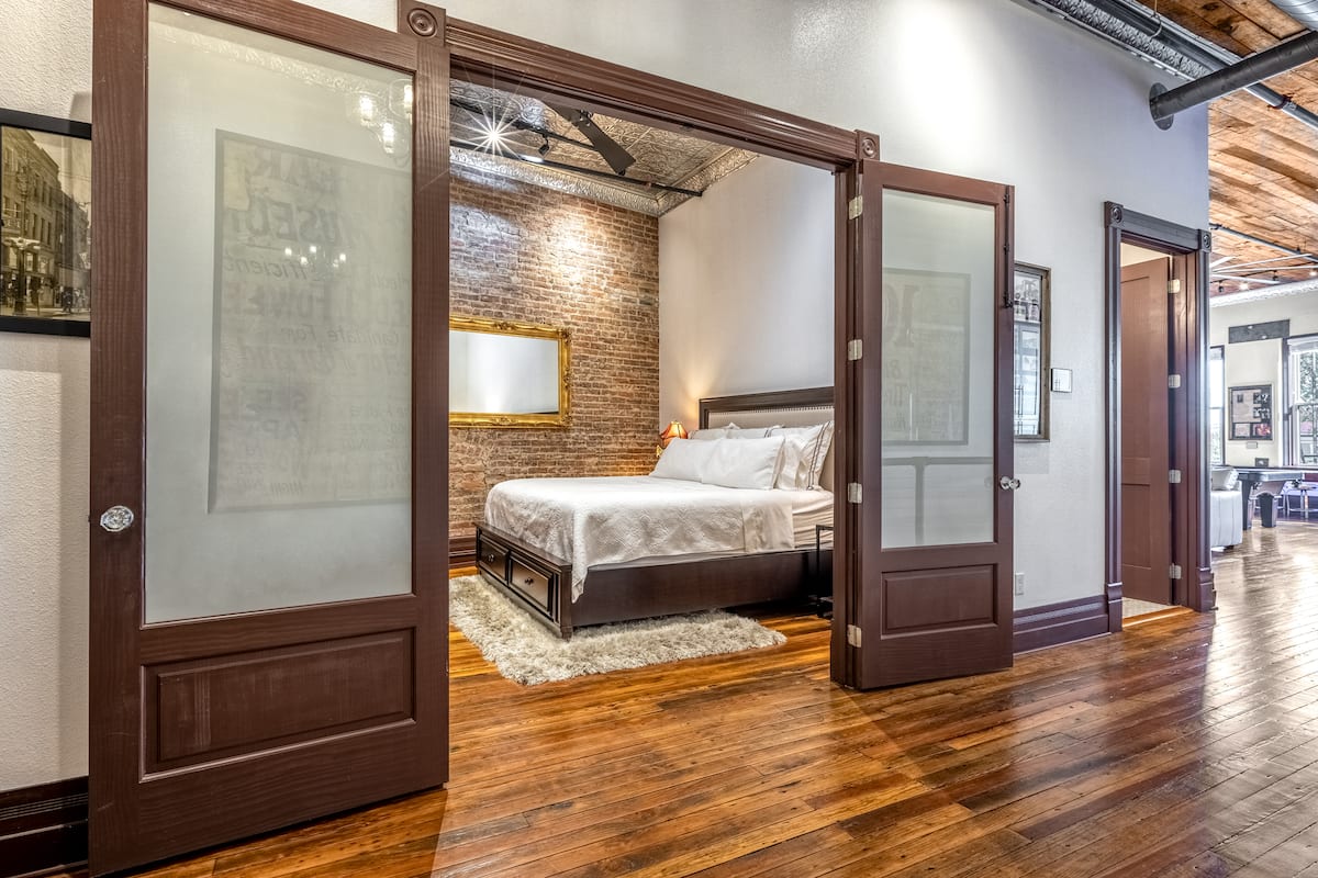 King bedroom suite through historic wood doors