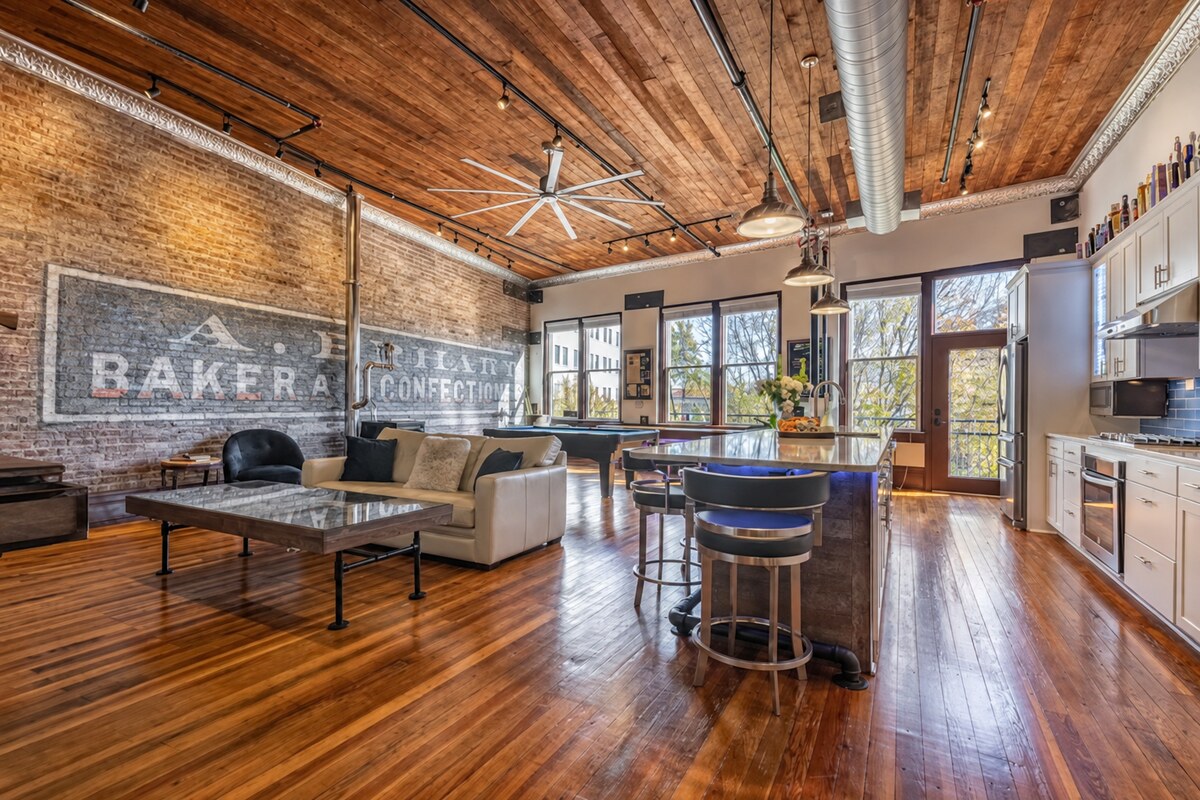 Wide view of the great room, pool table and kitchen