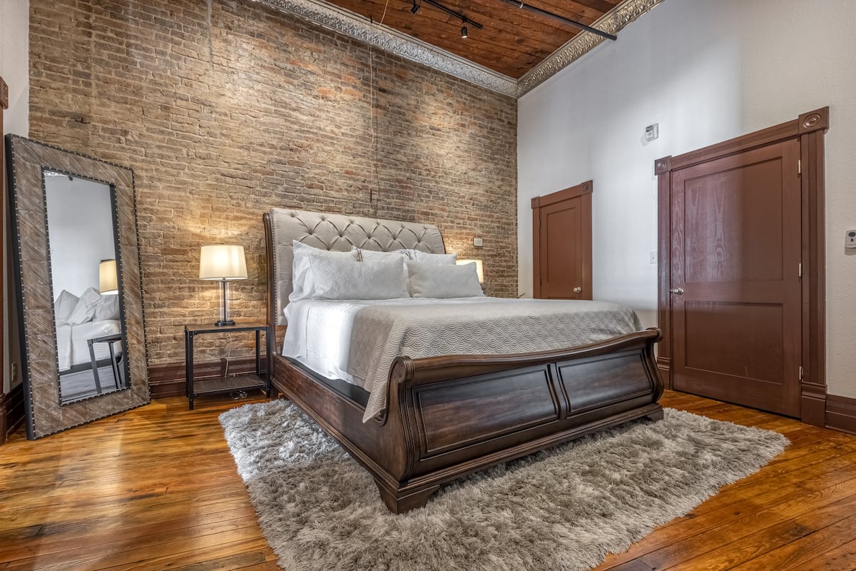 Second view of the brick-walled king bedroom